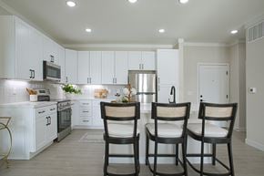 Liberty Township townhouse for rent - A kitchen with white cabinets and a grey floor.