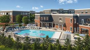 Liberty Township townhouse for rent - A large swimming pool surrounded by lounge chairs and trees.