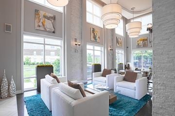 West Chester apartment for rent - A living room with white furniture and a blue rug.
