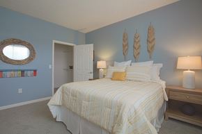 Mason apartment for rent - A bedroom with a bed, nightstand, and a mirror on the wall.