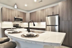 Cincinnati apartment for rent - A modern kitchen with a white countertop and stainless steel appliances.