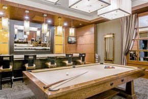 Baltimore apartment for rent - A pool table in a room with a mirror and a TV.
