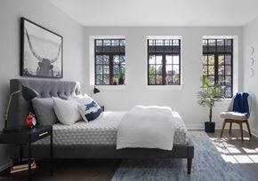 Chicago apartment for rent - a bedroom with a bed and three windows