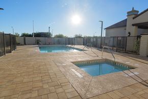 Las Vegas apartment for rent - A sunny day at the pool with a fence surrounding the area.