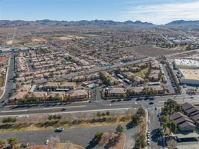 Henderson apartment for rent - A bird's eye view of a residential area with houses, roads, and vehicles.