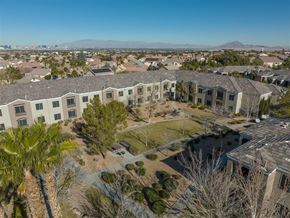 Henderson apartment for rent - A bird's eye view of a residential area with houses and palm trees.