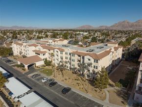 Las Vegas apartment for rent - A large apartment complex with a parking lot in front.