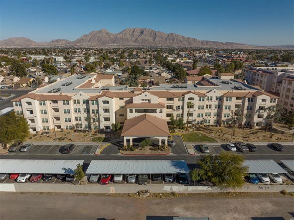 Las Vegas apartment for rent - A large building with a parking lot in front of it.