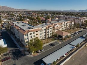 Las Vegas apartment for rent - A large apartment complex with a parking lot in front.
