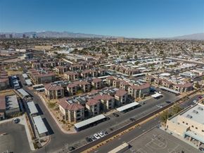 Las Vegas apartment for rent - A view of a residential area with apartment buildings and a basketball court.