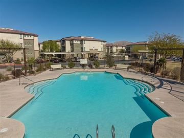 Las Vegas apartment for rent - A swimming pool in a residential area with apartment buildings in the background.