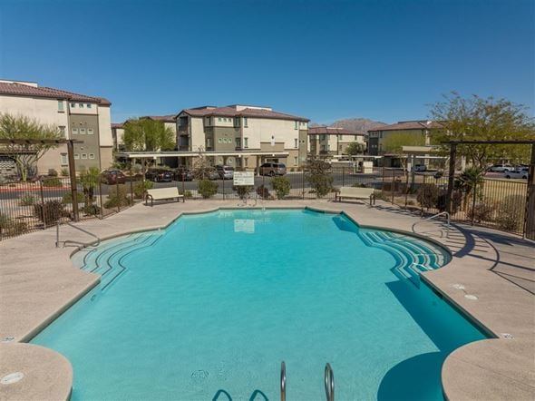 Las Vegas apartment for rent - A swimming pool in a residential area with apartment buildings in the background.