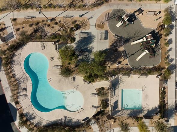 Las Vegas apartment for rent - An aerial view of a park with a large blue pool and a smaller pool.
