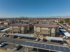 Las Vegas apartment for rent - A large building with a parking lot in front of it.