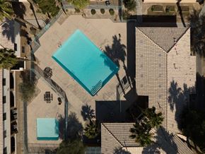 Las Vegas apartment for rent - A swimming pool surrounded by a fence and trees.