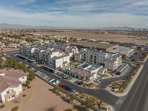 Las Vegas apartment for rent - A large apartment complex with a parking lot in front.