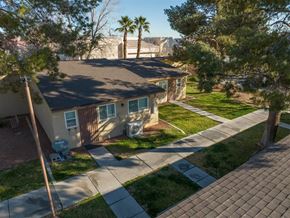 Las Vegas apartment for rent - A house with a driveway and a tree in front.