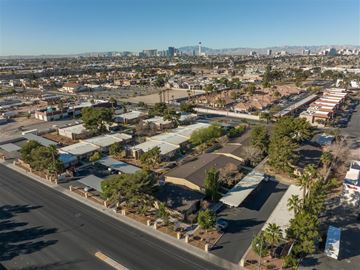 Las Vegas apartment for rent - A cityscape with buildings and trees under a clear sky.