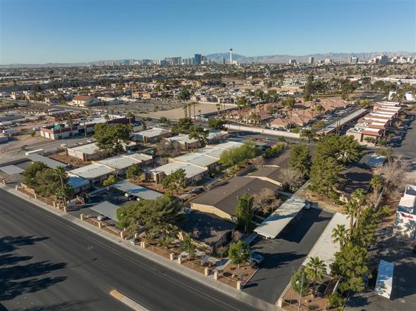 Las Vegas apartment for rent - A cityscape with buildings and trees under a clear sky.