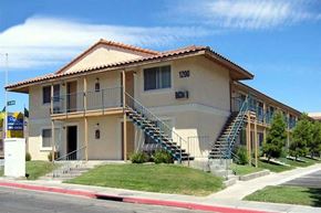 Las Vegas apartment for rent - A building with a red tile roof and a sign that says 1200 on it.