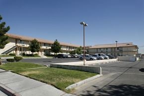 Las Vegas apartment for rent - A parking lot in front of a building with cars parked.