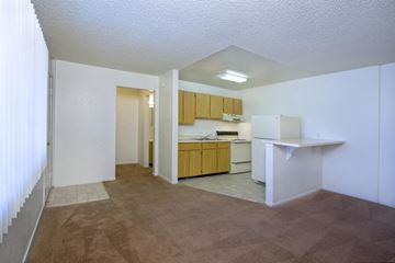 Las Vegas apartment for rent - A kitchen area with a white counter and brown carpet.