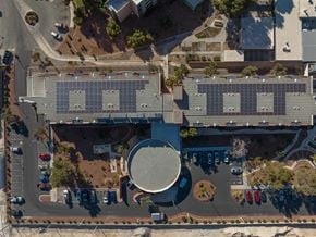 Las Vegas apartment for rent - A large building with a circular structure in the middle of a parking lot.