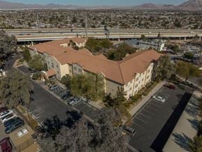 Las Vegas apartment for rent - A large building with a parking lot in front of it.