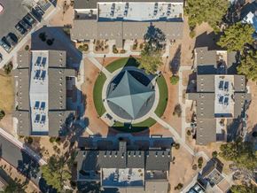 Las Vegas apartment for rent - A large building with a green lawn in front of it.