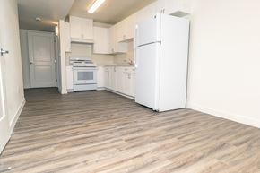 North Las Vegas apartment for rent - A kitchen with white appliances and wooden floors.