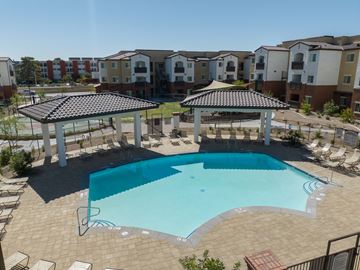 Las Vegas apartment for rent - an aerial view of a swimming pool in front of an apartment building