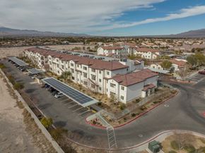 Las Vegas apartment for rent - A large building with a parking lot in front of it.