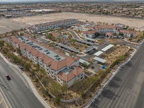 Las Vegas apartment for rent - A large apartment complex is surrounded by a parking lot and a road.