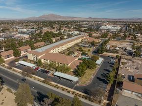 Las Vegas apartment for rent - A large building with a parking lot in front of it.