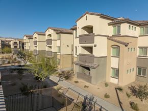 Las Vegas apartment for rent - an aerial view of a row of apartment buildings with a gate and a street