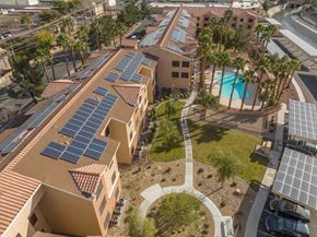 Las Vegas apartment for rent - A building with solar panels on the roof and a pool in the courtyard.