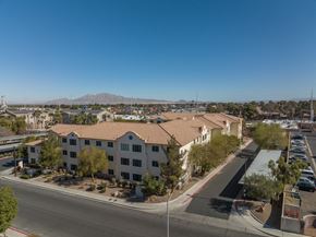 Las Vegas apartment for rent - an aerial view of a building with a parking lot and a street
