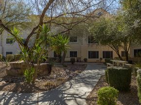 Las Vegas apartment for rent - a courtyard in front of a building with trees and plants