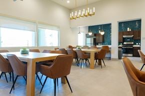 Las Vegas apartment for rent - A modern dining room with a long table and chairs.