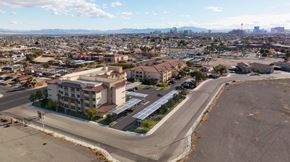 North Las Vegas apartment for rent - A large building with a parking lot in front of it.