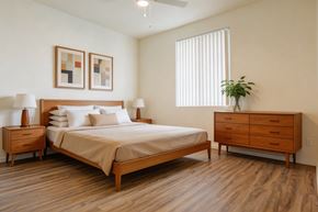 Las Vegas apartment for rent - A bedroom with a bed, nightstands, and a plant.