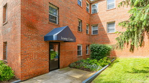 Washington apartment for rent - A brick building with a Leasing Center awning at Eagles Crossing Apartments, Washington