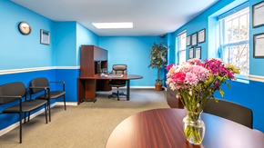 Washington apartment for rent - A conference room with a table, chairs, and a vase of flowers at Eagles Crossing Apartments, Washington DC