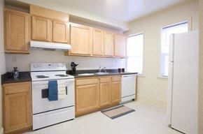 Washington apartment for rent - A kitchen with wooden cabinets and a white stove.