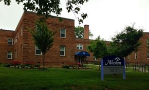 Washington apartment for rent - A brick building with a sign that says Milestone in front of it.