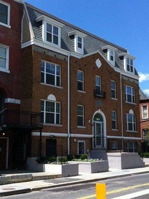 Washington apartment for rent - A red brick building with white trim and windows.