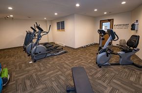 Grand Forks apartment for rent - A gym with a variety of equipment including treadmills, stationary bikes, and weight machines.