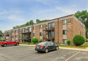 Grand Forks apartment for rent - A red truck is parked in front of a brick apartment building.