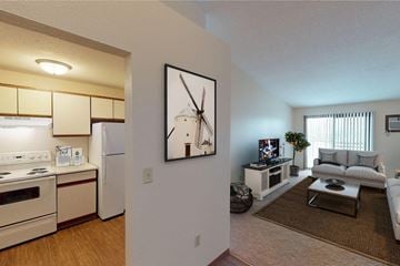 Grand Forks apartment for rent - A living room with a couch, a coffee table, and a painting on the wall.