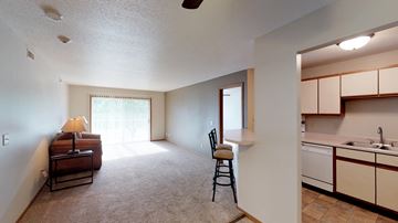 Sioux Falls apartment for rent - A living room with a brown couch and a chair.